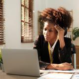Woman on computer frustrated with insurance