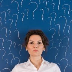 Woman surrounded by question marks