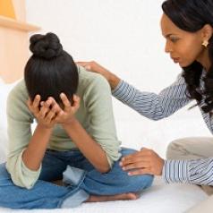 Mother comforting her upset teenage girl