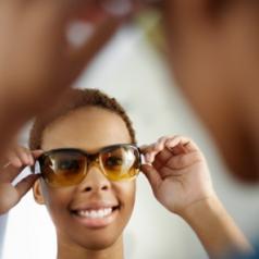 Young Woman Trying on Sunglasses