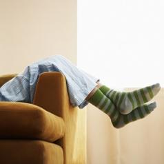 Person in pajamas resting on couch