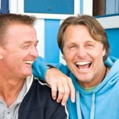Two men laughing together