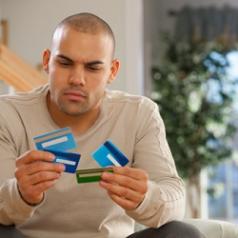 Man holds multiple credit cards