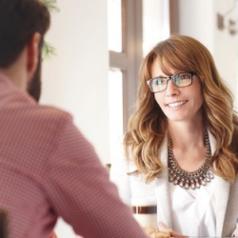 Woman looks attentively at man in during consultation
