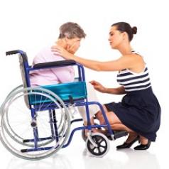 Woman comforting another woman in a wheelchair