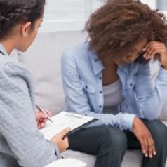 Woman with curly hair sitting on therapist