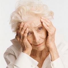 Elderly woman holding face