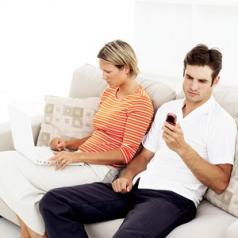 Couple using technology and ignoring each other