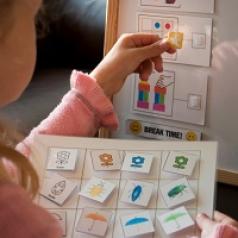 Young girl putting stickers on a board