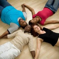 Group lying down and meditating together