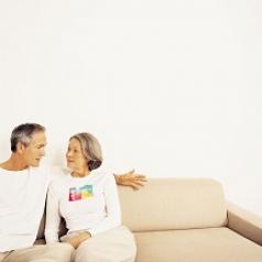 Older couple talking on couch