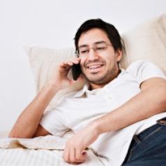 Man in bed on phone