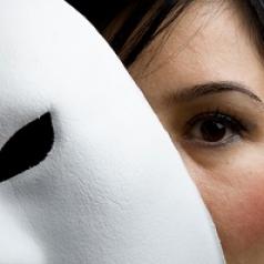 woman hiding behind mask