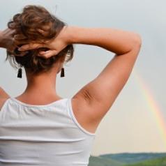 woman looking at rainbow