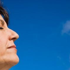 woman with eyes closed in the sunlight