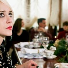 young woman looking anxious at holiday dinner