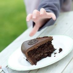 Child reaches for Chocolate Cake