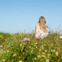 girl sitting in meadow