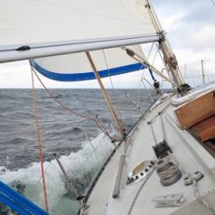 Sailboat yacht sailing in blue se