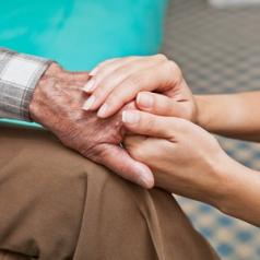 holding hands of elderly grieving person