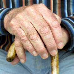 older man grasping cane
