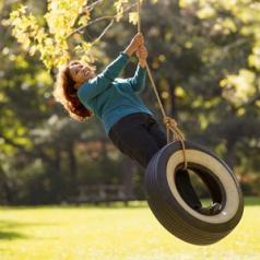 woman swinging on tire swing