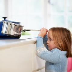 Child reaches for stovetop pan