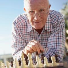 Senior man plays chess