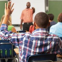 A student raises his hand in class