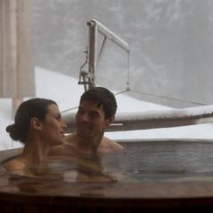 Couple in hot tub, outside