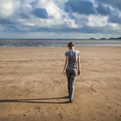 Woman Walking Towards the Sea