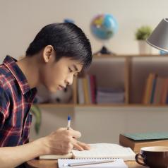 An Asian student studies