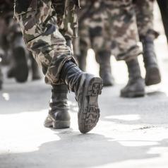 Marching feet of soldiers in fatigues and combat boots