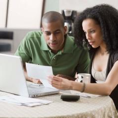Couple at home on laptop computer