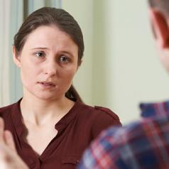 Depressed Young Woman Talking To Counselor