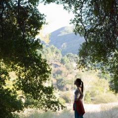 woman looks out at montains and trees