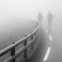 Couple walking in the fog