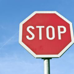 Stop road traffic sign over blue sky