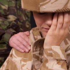 A female soldier cries while another soldier comforts her