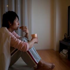 Person watches tv while eating popcorn