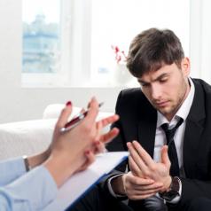 Oppressed man talking with psychologist