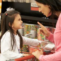 Girl Having Argument With Mother At Candy Counter