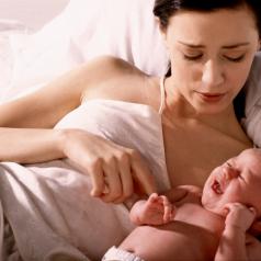 Mother lying in bed with newborn