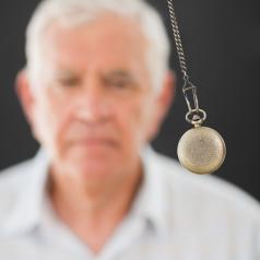 Man being hypnotized with a pendulum