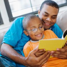 Father and son reading together