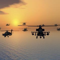 Modern combat helicopters flying over water