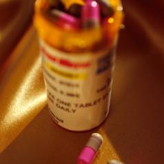 Close-up of open bottle of prescription drugs