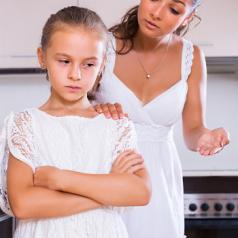 Mother talking to daughter about behavior
