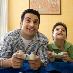 Father playing video games with his son