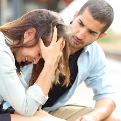Man comforting sad crying woman